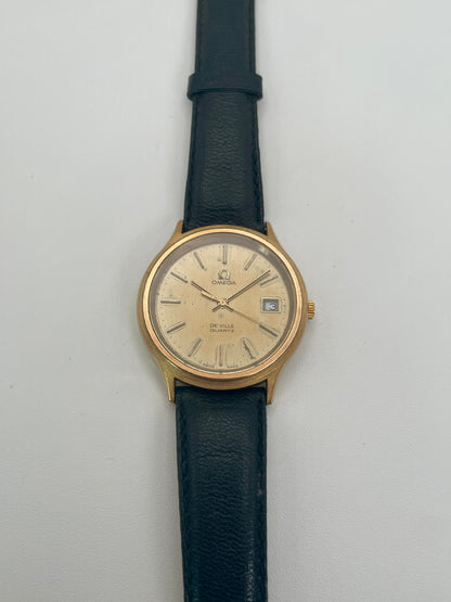 Omega De Ville 192.0033 vintage watch in gold with black strap, front face view
