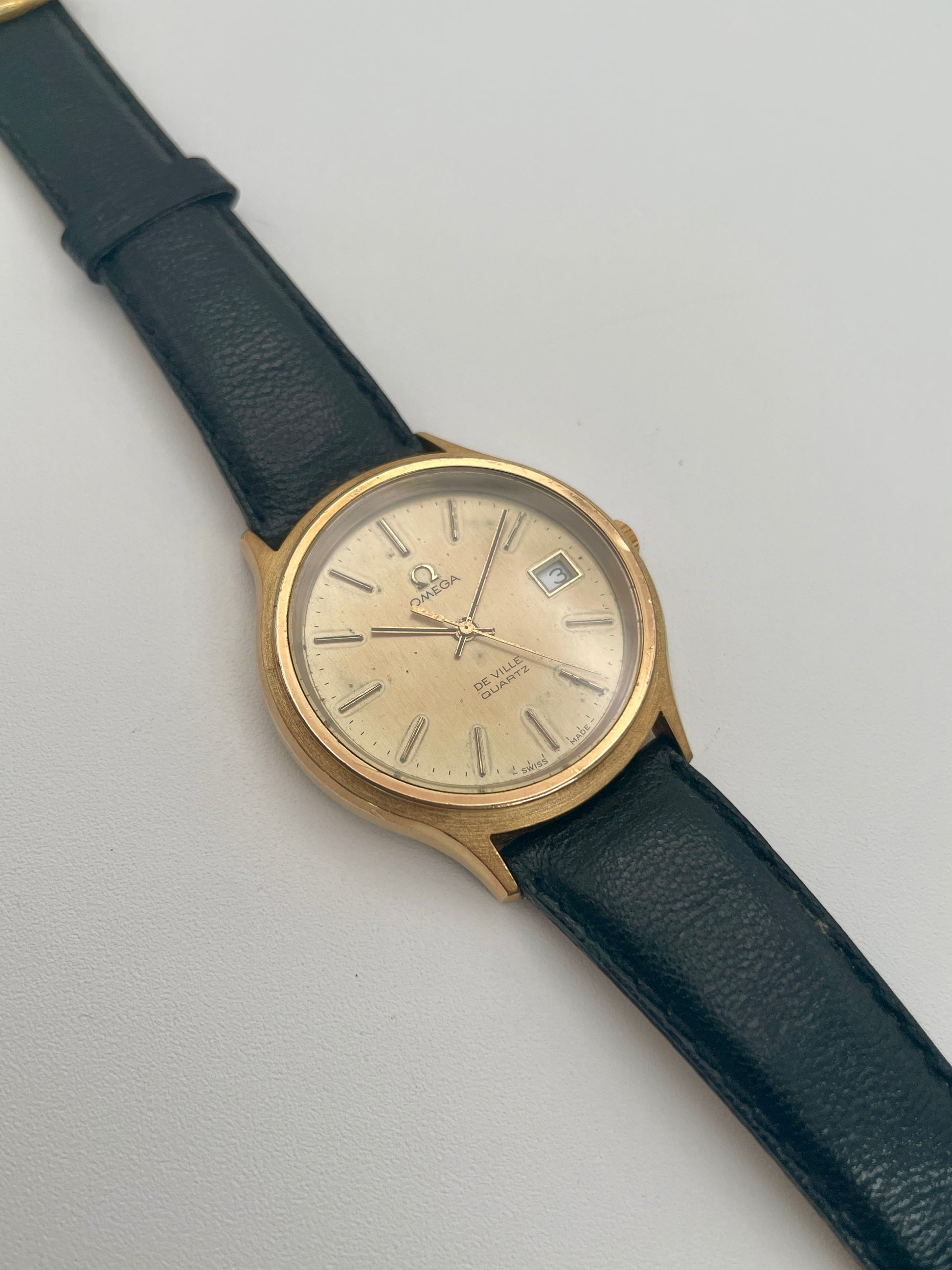 Omega De Ville 192.0033 vintage watch in gold with black strap, main view
