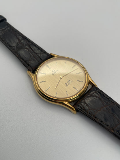 Omega Deville Classic Ref 191.0130 gold watch with a round case, gold dial, and black leather strap.