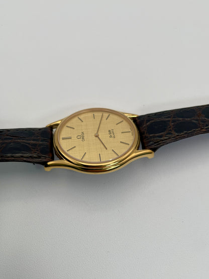 Side view of Omega Deville Classic Ref 191.0130 gold watch with a round case, gold dial, and black leather strap.