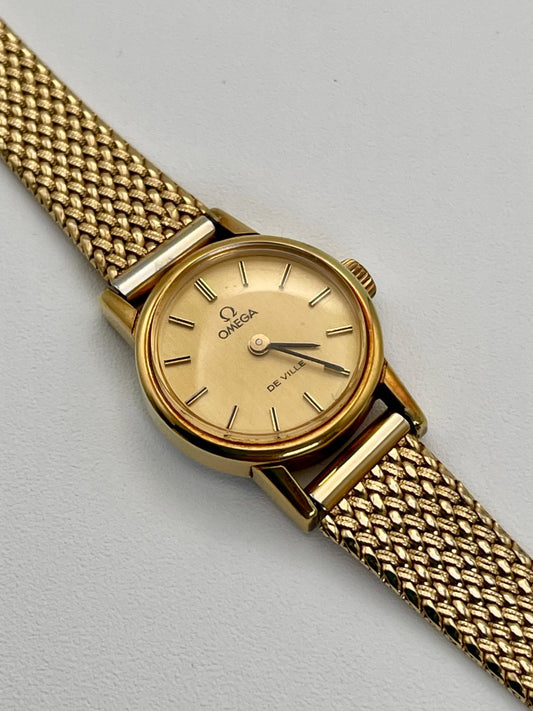 Vintage Omega De Ville ladies watch in gold with mesh bracelet, main view.