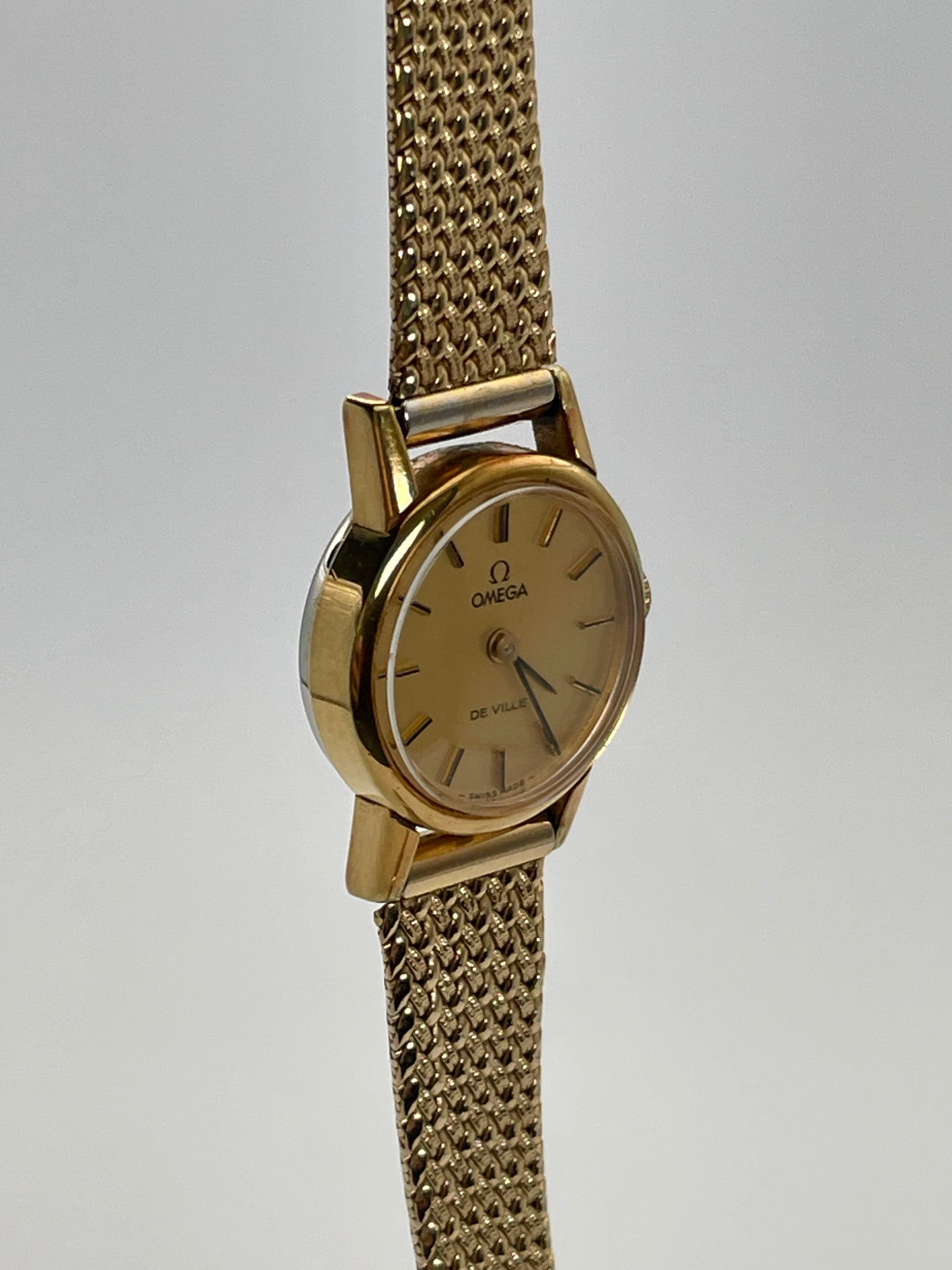 Side view of the vintage Omega De Ville ladies watch in gold with mesh bracelet.