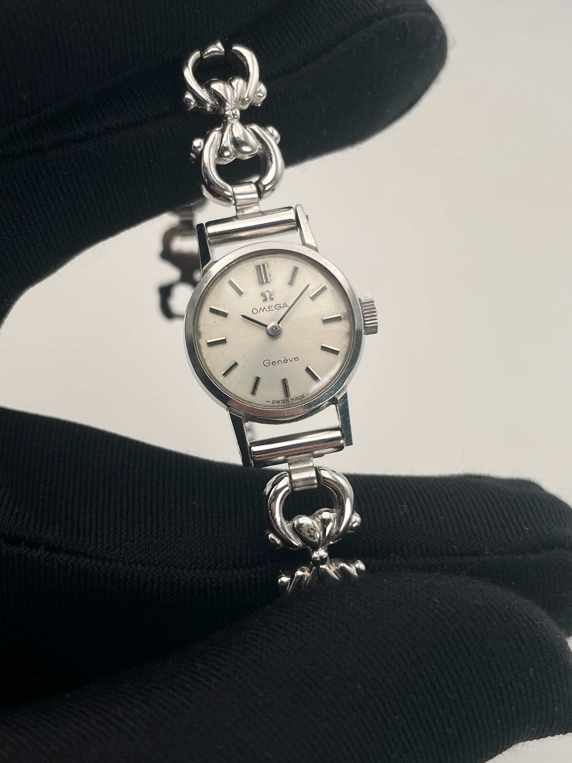 Close-up view of Omega Genève ladies watch in silver-tone, highlighting the dial and bracelet details.