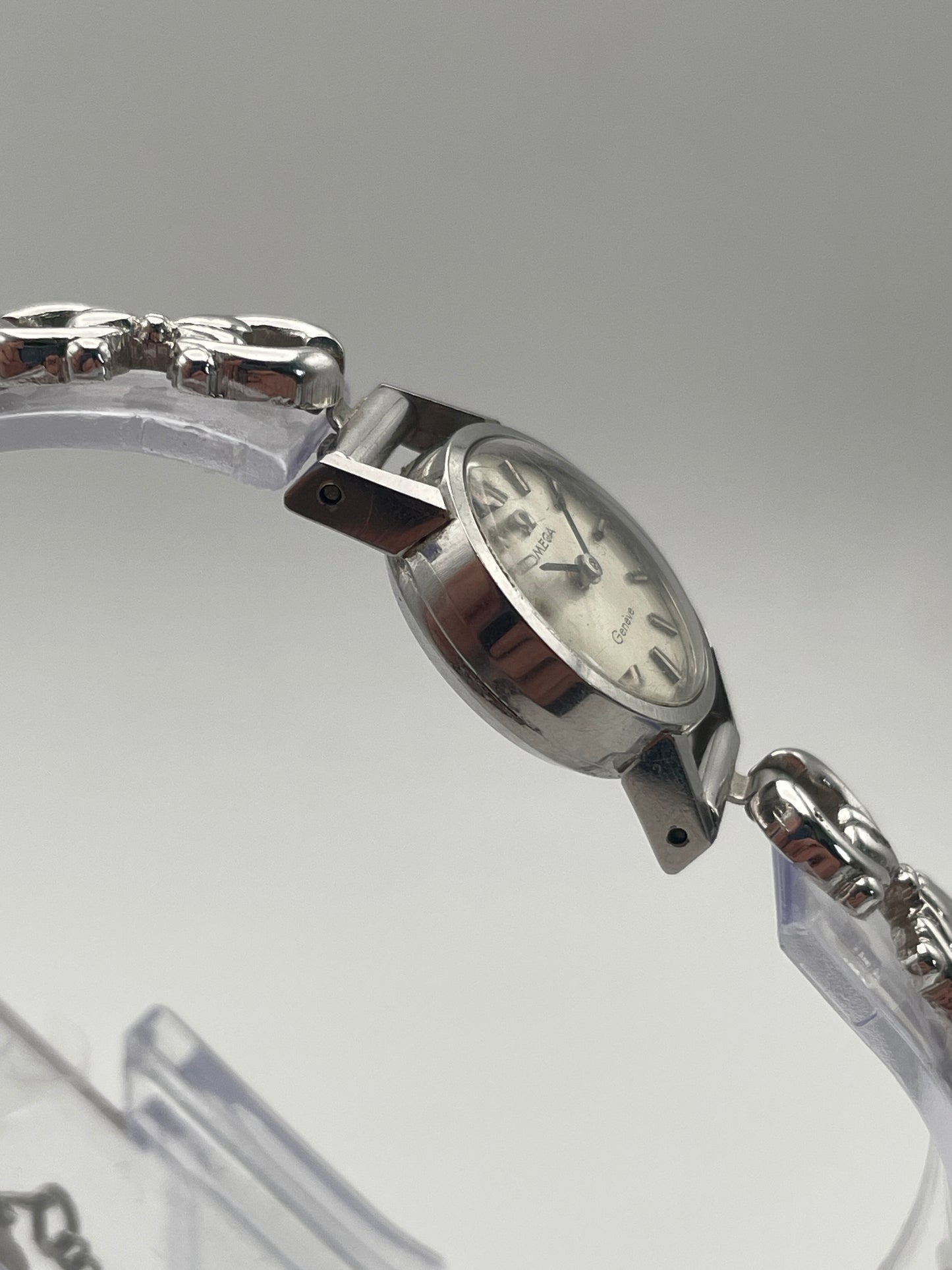 Side view of Omega Genève ladies watch showing the silver-tone case and bracelet attachment.