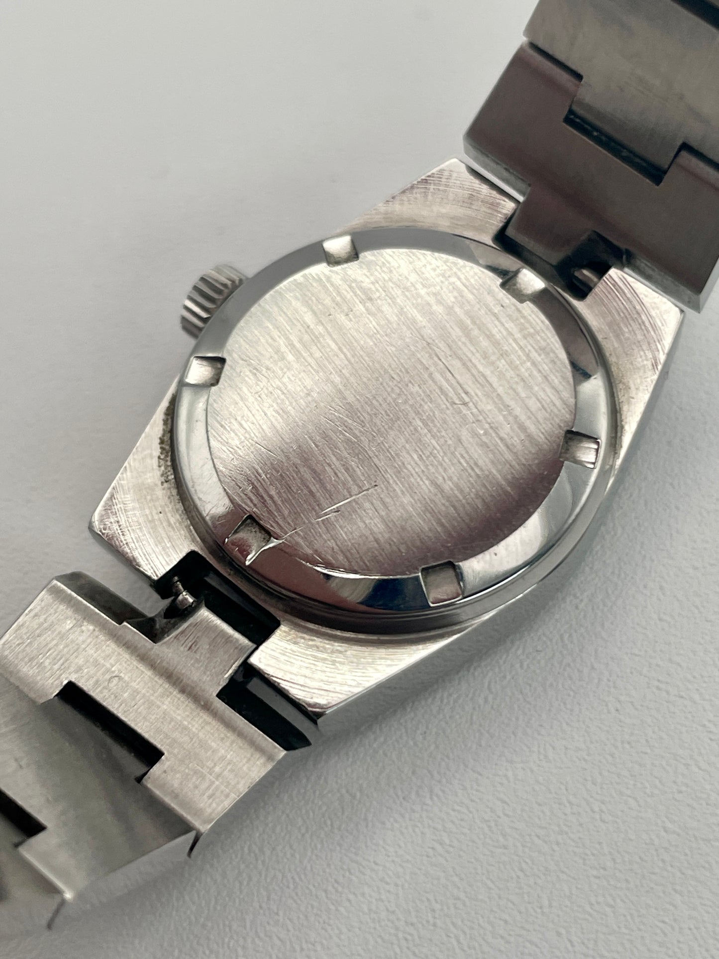 Caseback view of Omega Geneve 535.0028, showing the brushed steel design and integrated bracelet clasp.