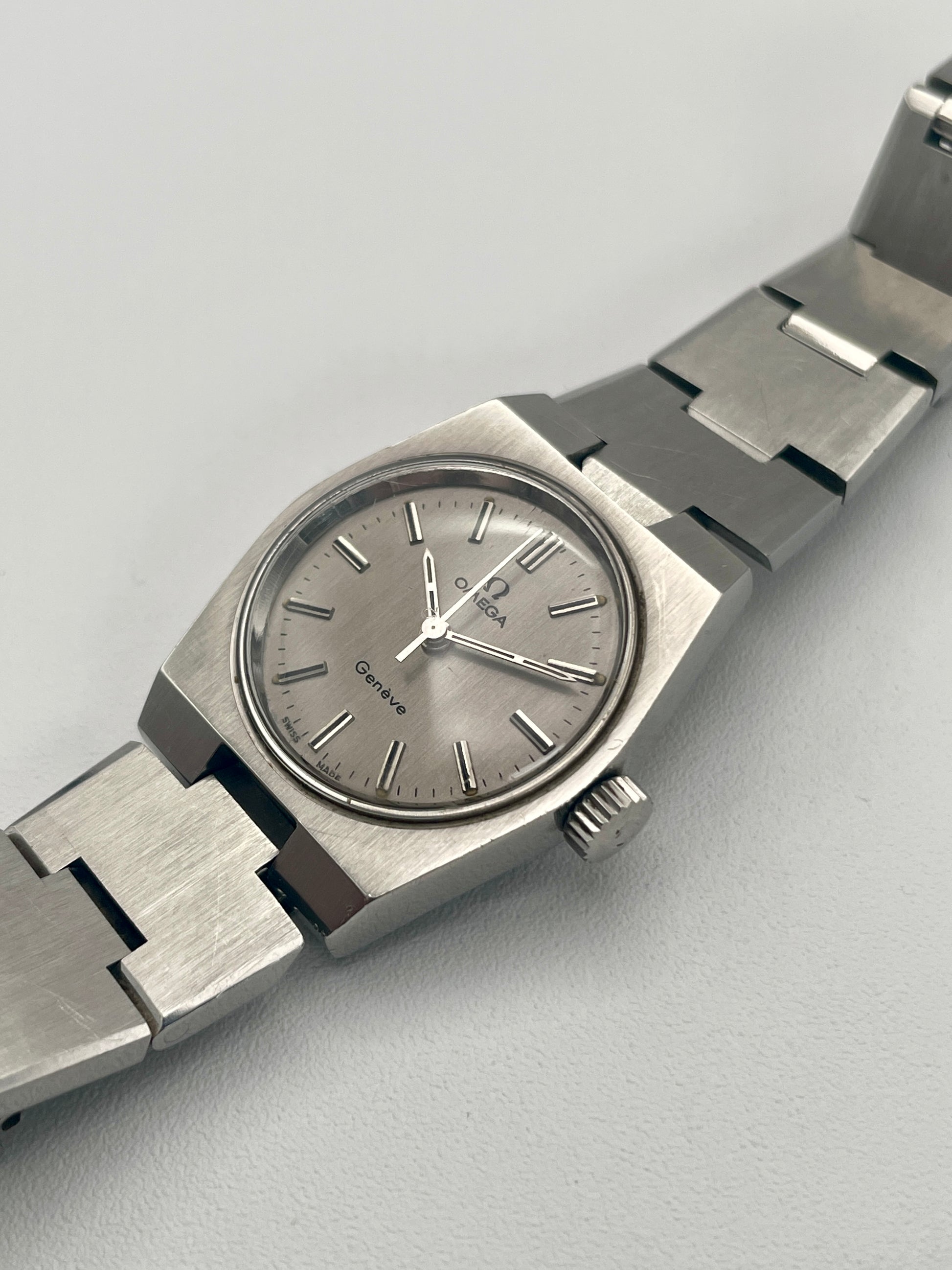 Diagonal view of Omega Geneve 535.0028, highlighting the sleek brushed steel case and minimalist dial design.