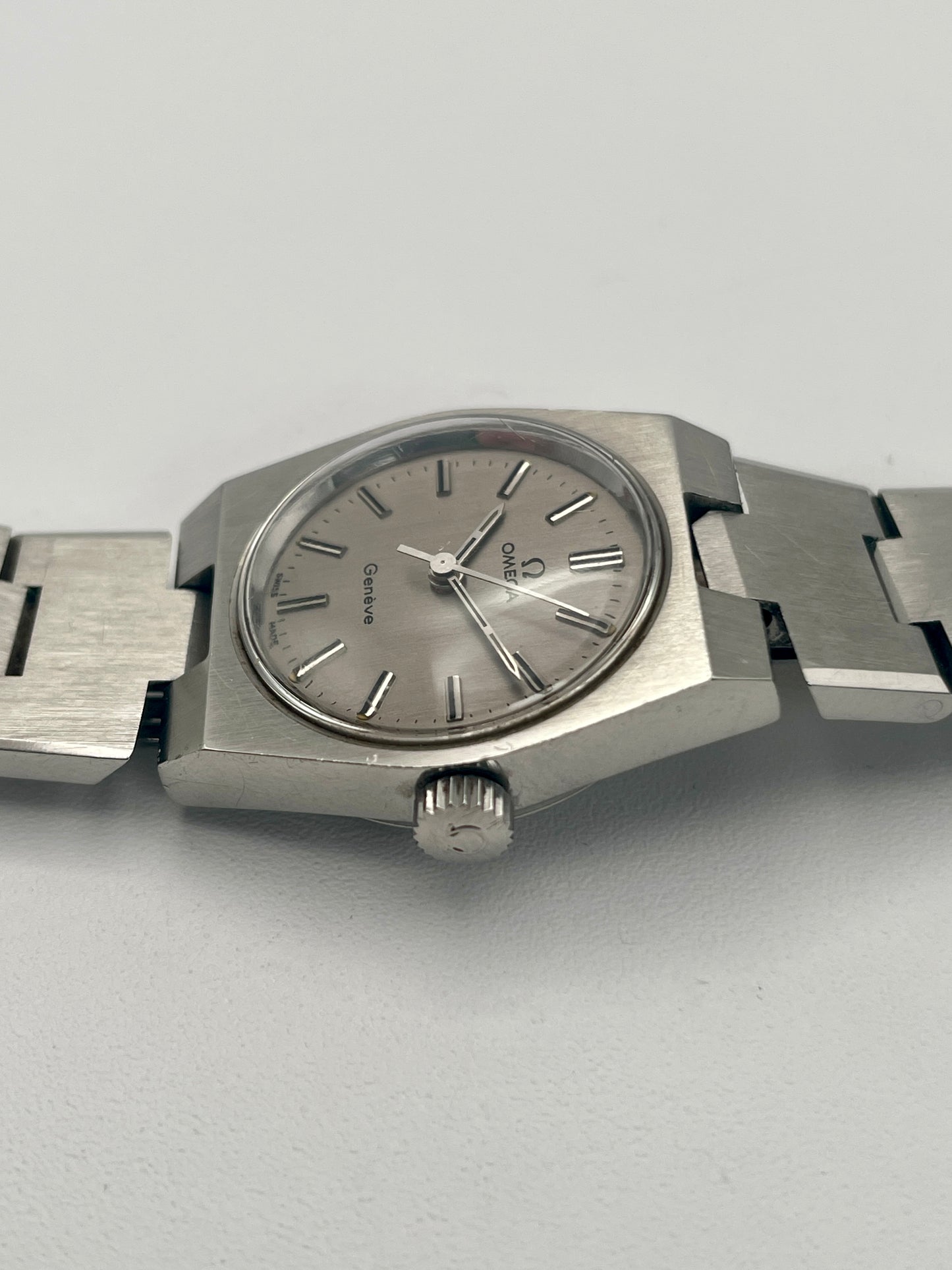 Side profile of Omega Geneve 535.0028 showcasing the stainless steel case and crown.