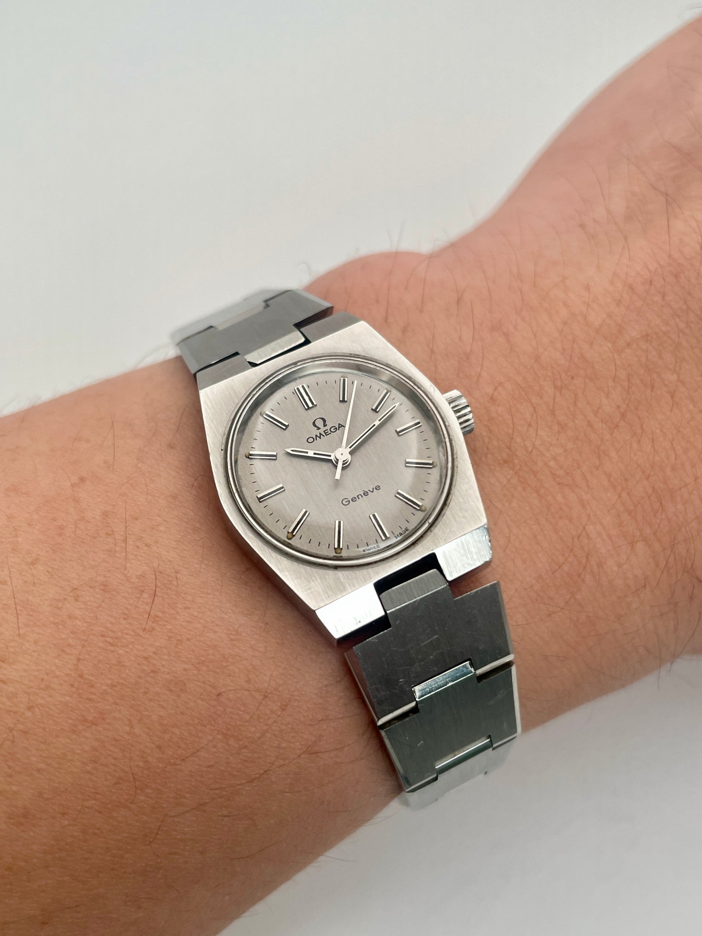 Wrist shot of Omega Geneve 535.0028, showing the watch on a wrist with its stainless steel bracelet.