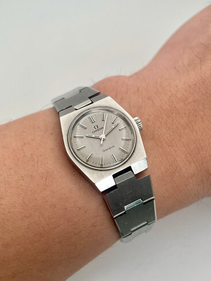 Wrist shot of Omega Geneve 535.0028, showing the watch on a wrist with its stainless steel bracelet.