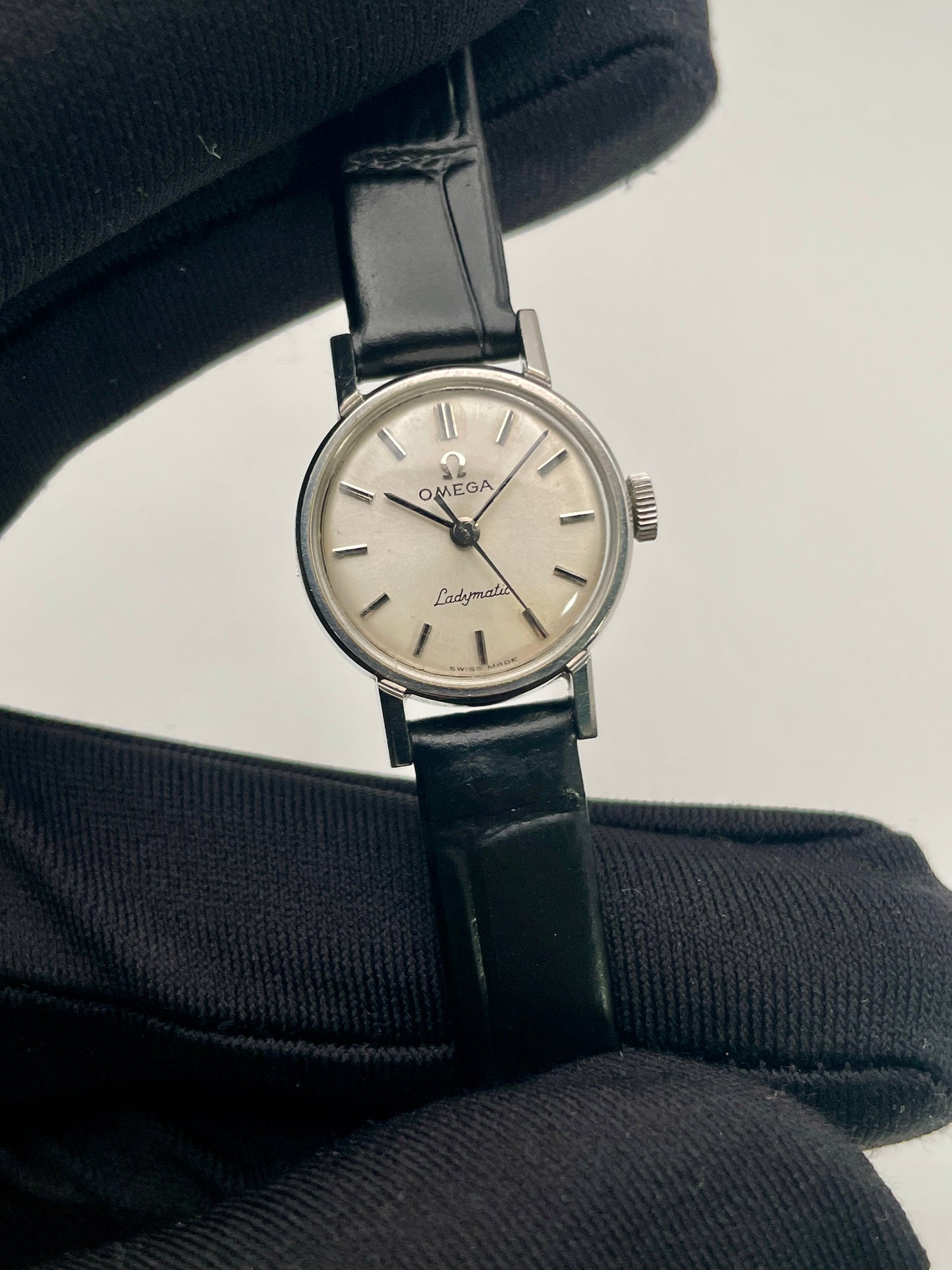 Close-up view of the Omega Ladymatic Vintage Women's Watch, showcasing the refined sunburst dial and elegant dauphine hands.