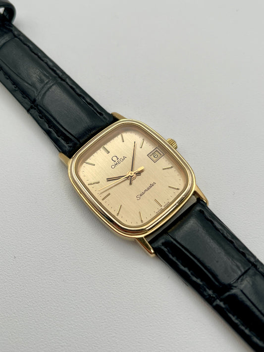Omega Seamaster Tank vintage women's watch in gold with black strap, main view
