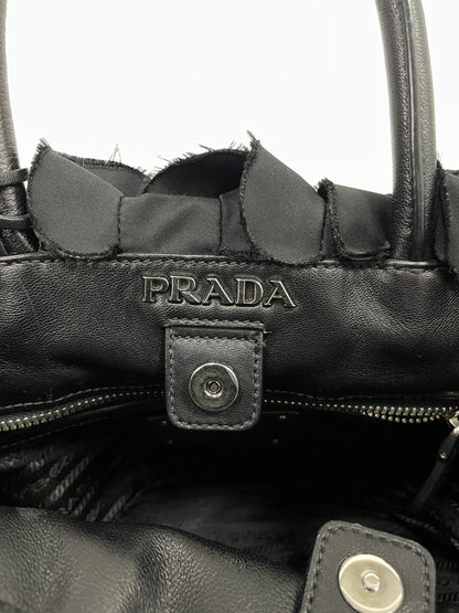 Close-up of the Prada logo on the interior of the Tessuto Ruffle Bag in black nylon with a branded lining.