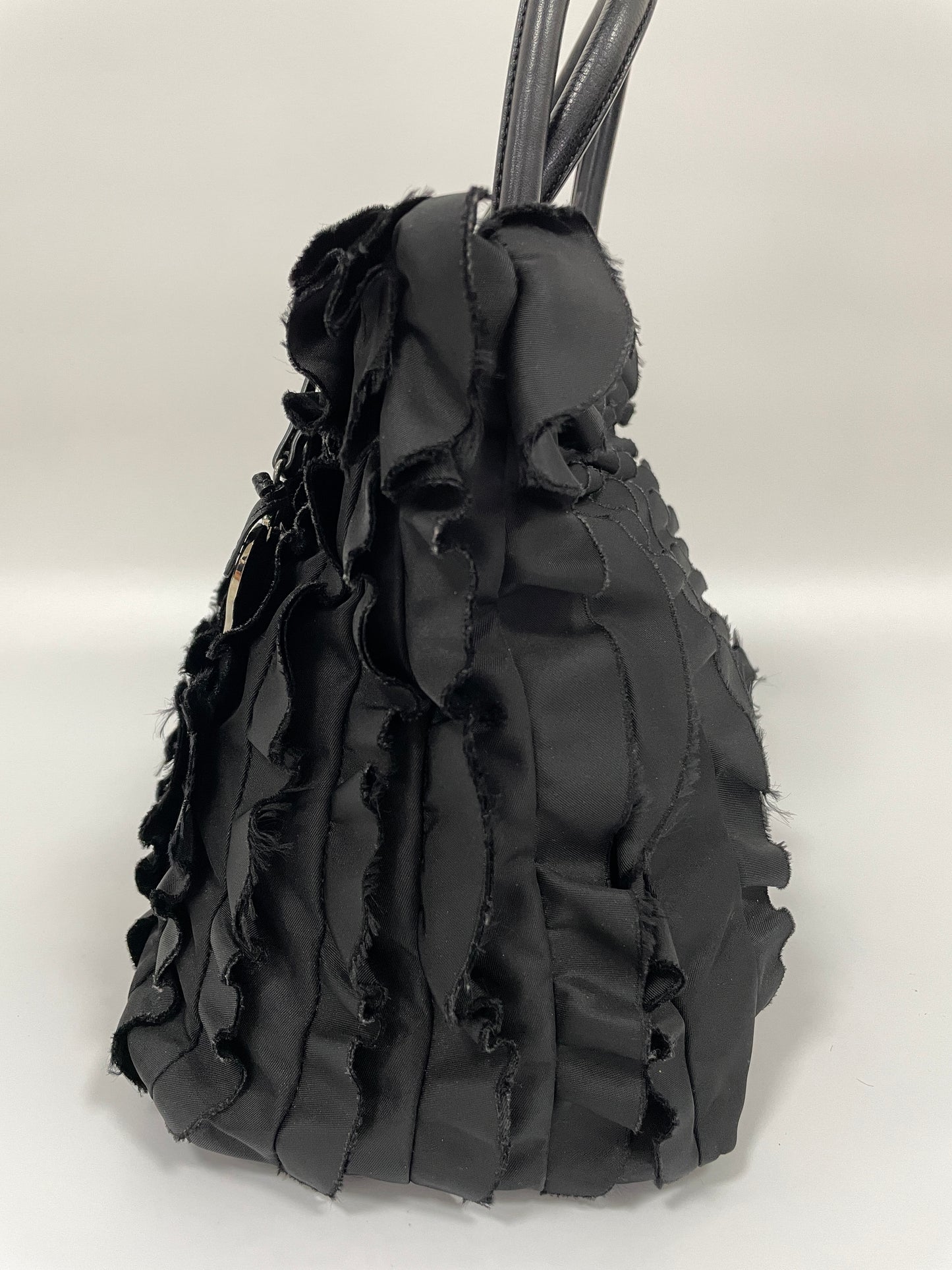 Right side view of Prada Tessuto Ruffle Bag in black nylon, showing the intricate ruffle design on the sides.