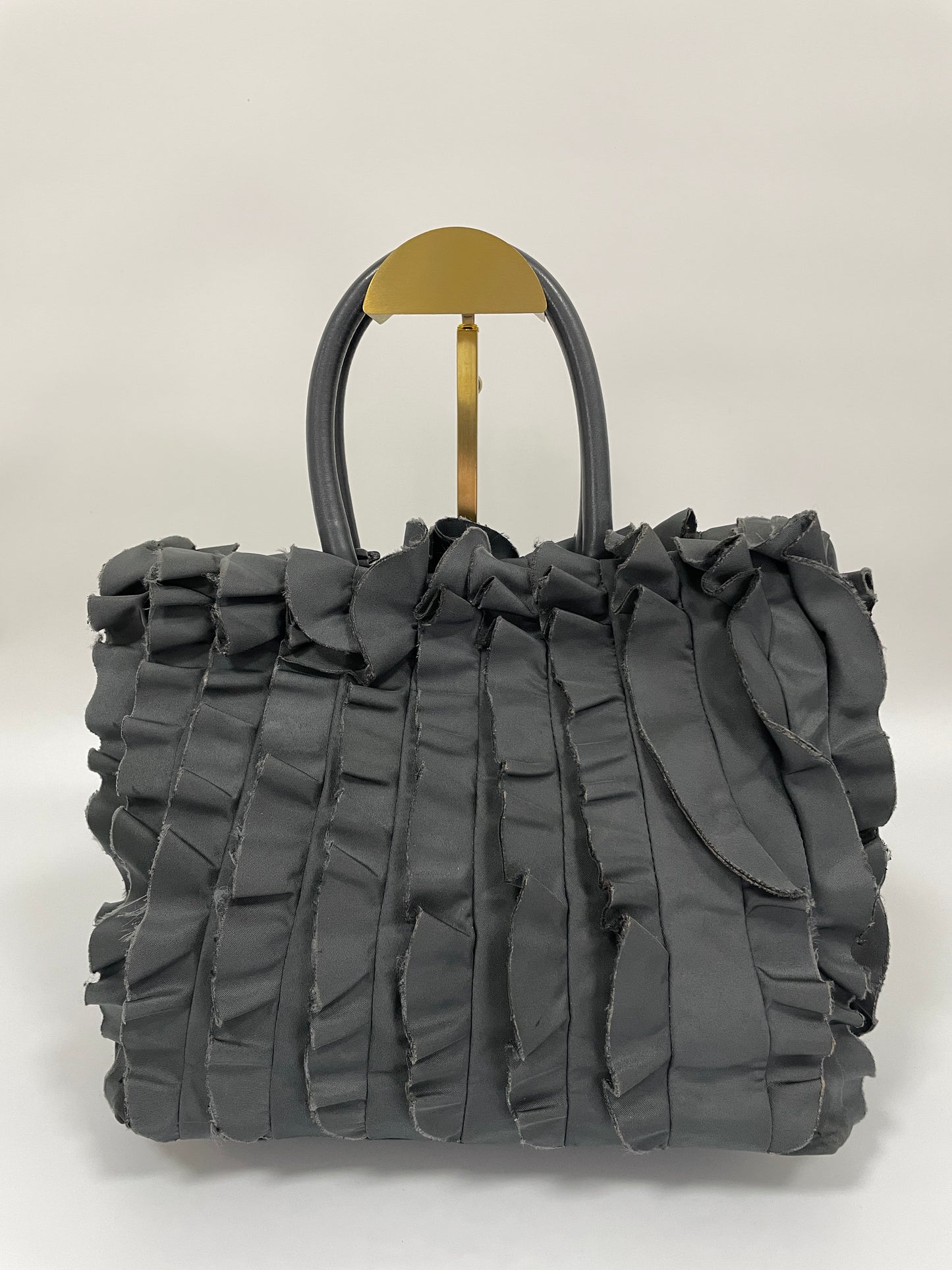 Back view of Prada Tessuto Ruffle Bag in grey nylon, highlighting the layered ruffles.
