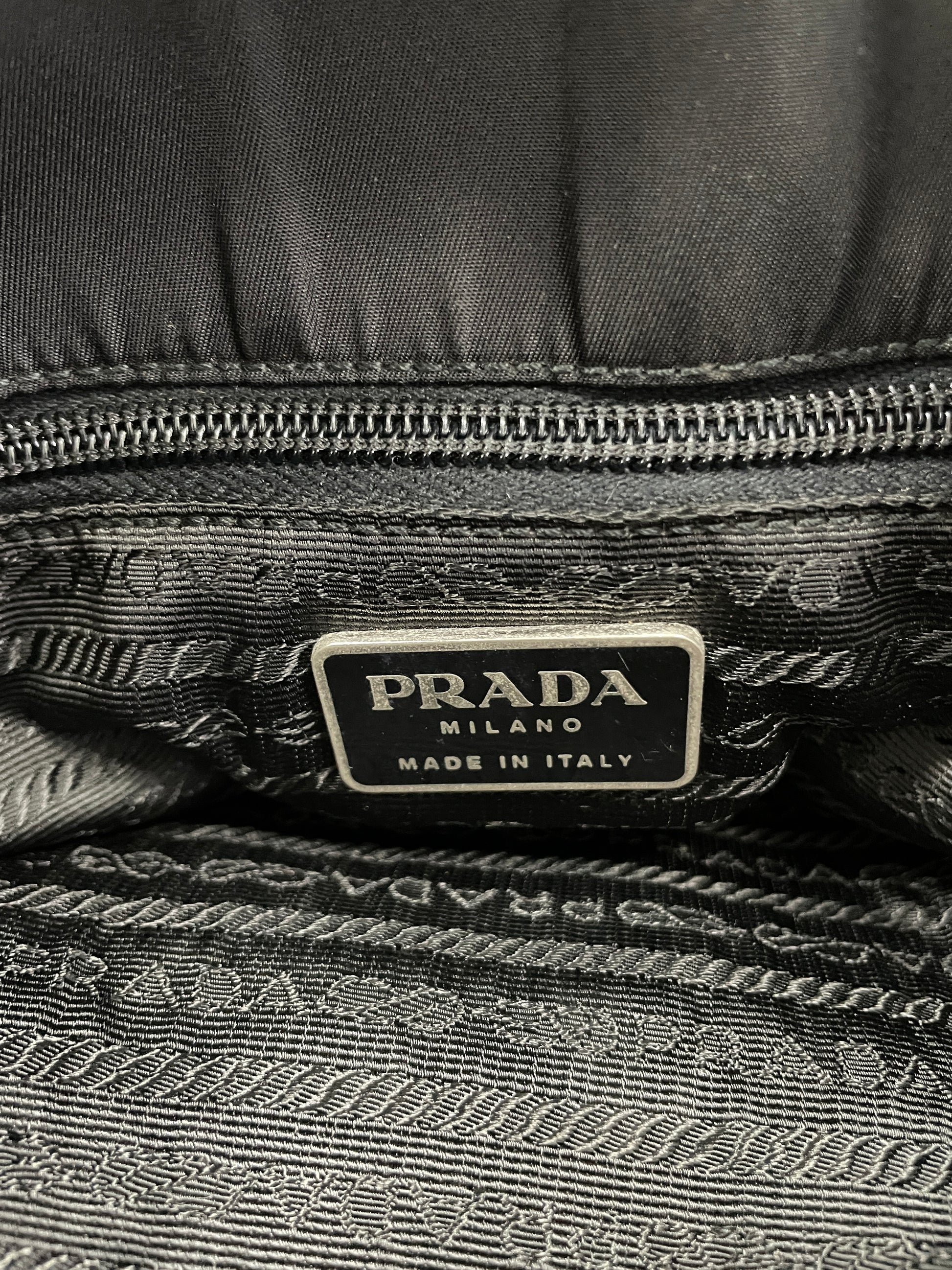 Interior view of the Prada Tessuto Tote Bag in black nylon, featuring the Prada Milano logo tag and signature jacquard lining.