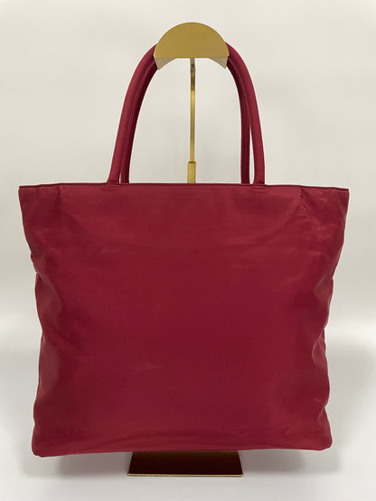 Back view of a Prada Tessuto Tote Bag in red nylon with dual handles.