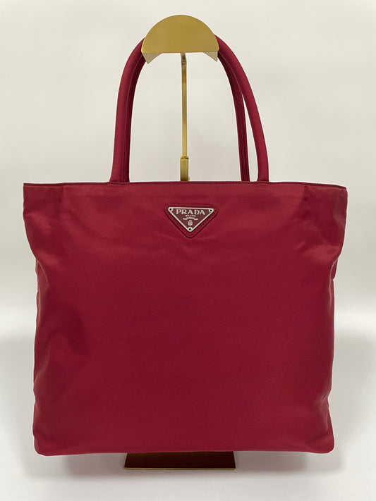 Front view of a Prada Tessuto Tote Bag in red nylon with dual handles and the Prada triangle logo.