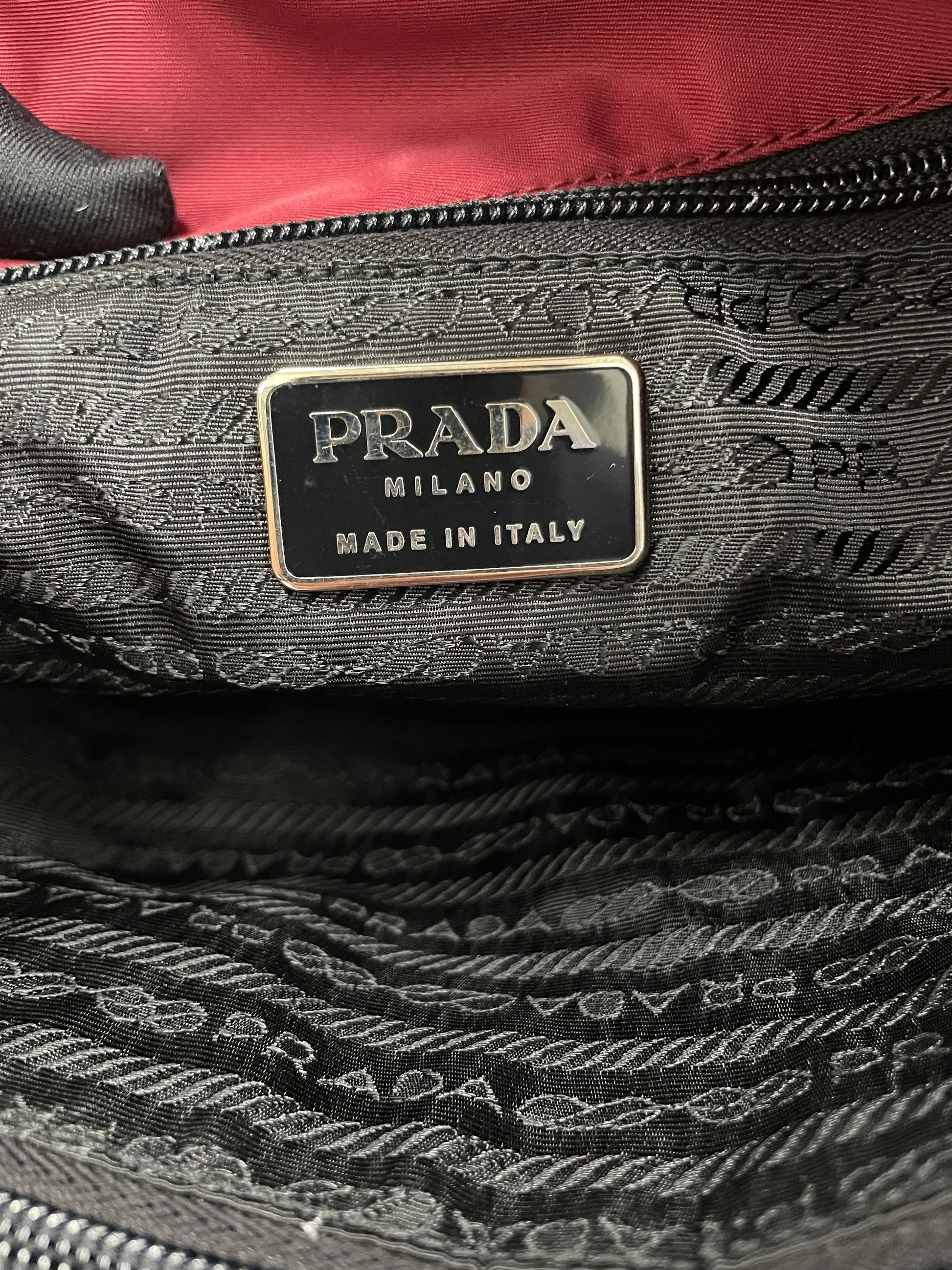 Interior view of the Prada Tessuto Tote Bag in red nylon displaying the iconic Prada logo.