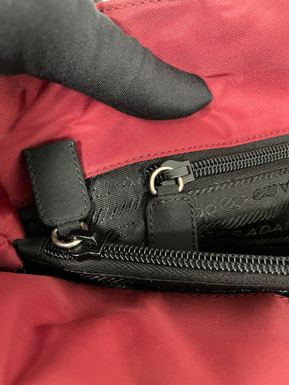 Close-up of the interior zipper detail on the Prada Tessuto Tote Bag in red nylon showcasing the black zippered compartment.