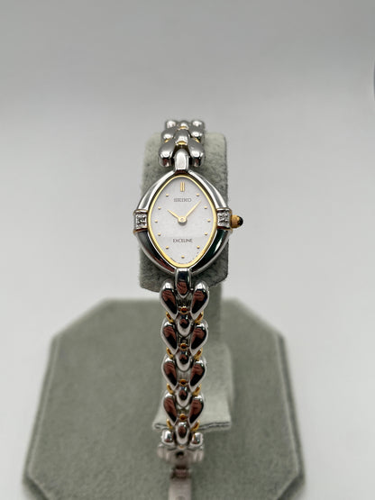 Seiko Exceline vintage watch showing off-center angle of white dial and unique bracelet links

