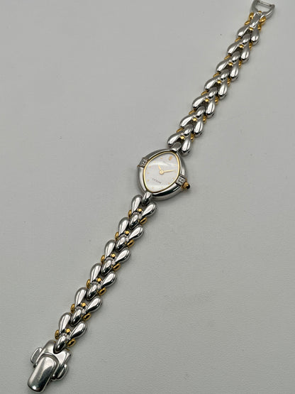 Full watch view laid flat, displaying the entire bracelet and teardrop case
