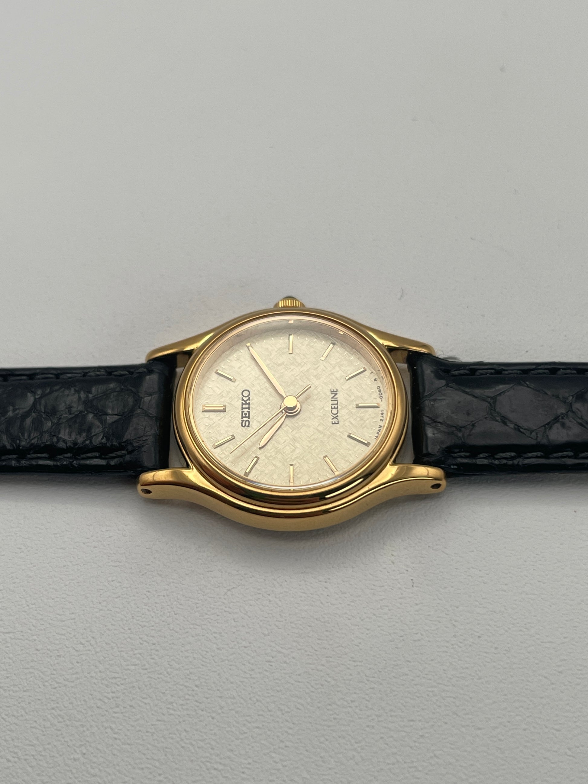 Left profile view of Seiko Exceline gold watch, highlighting the slim gold-plated case.