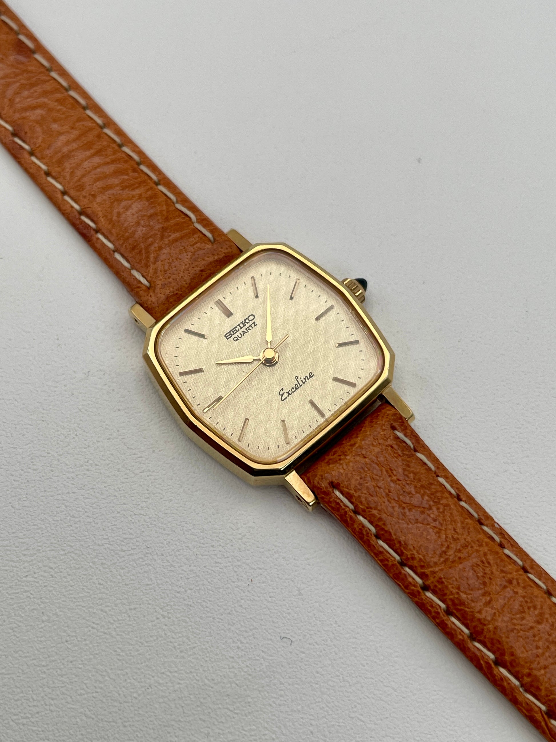 Main view of Seiko Exceline vintage women's watch in gold with tan leather strap, highlighting the unique octagonal case shape.

