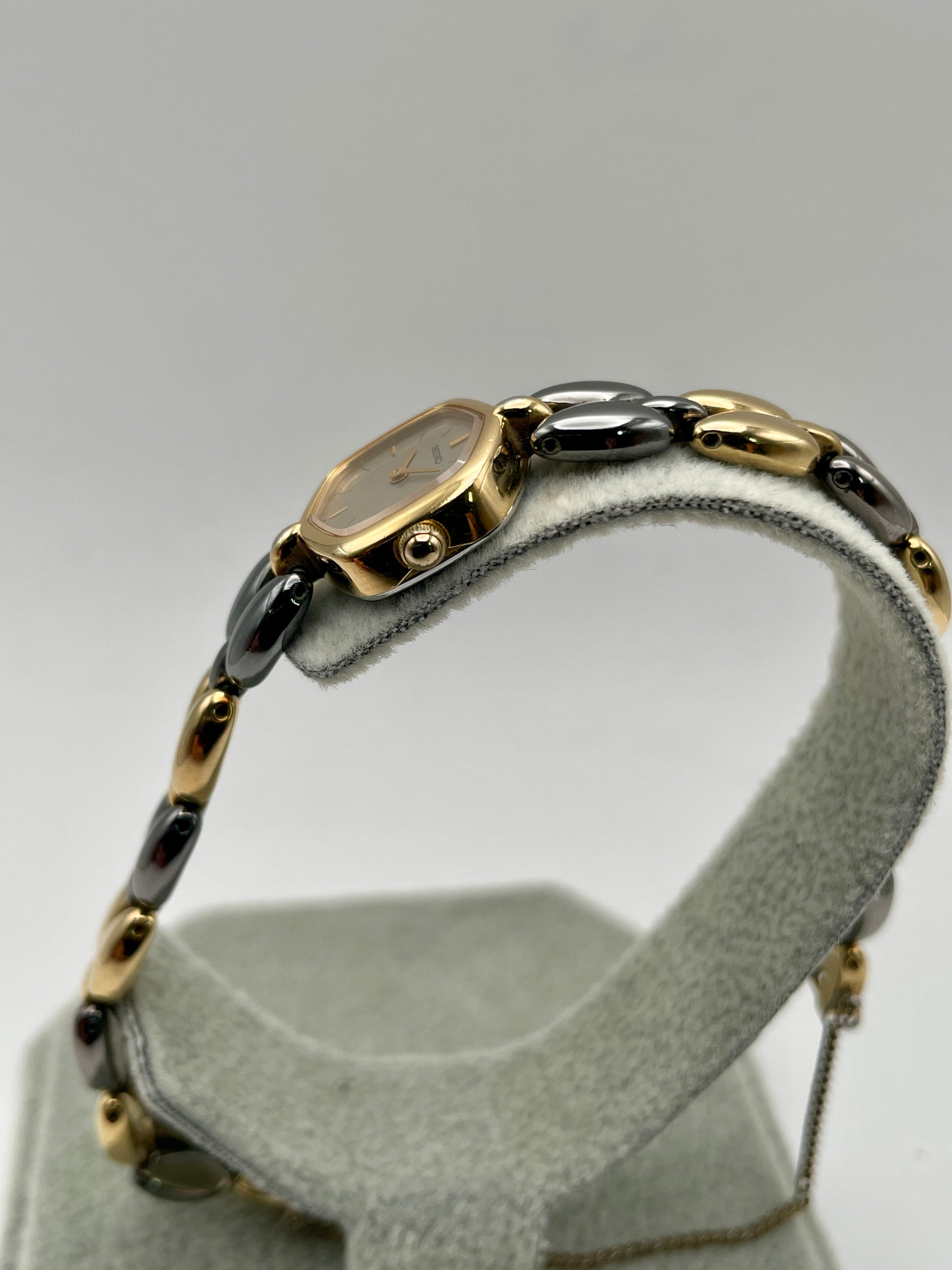 Crown-side view of Seiko Hexagon watch with unique bracelet link details and safety chain
