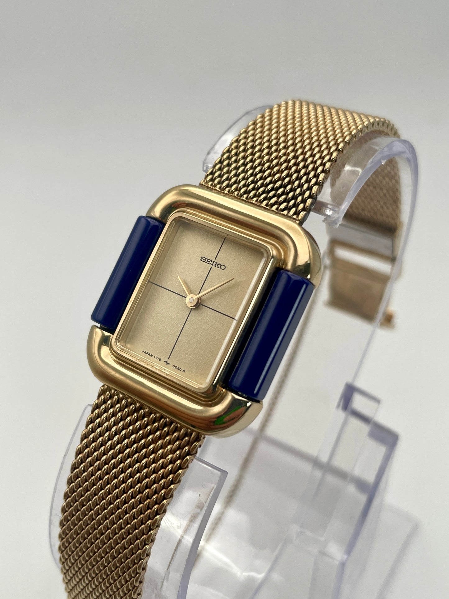 Angled view of Seiko Hidden Crown 1719-3070 vintage ladies' watch showcasing its gold case and blue accents.