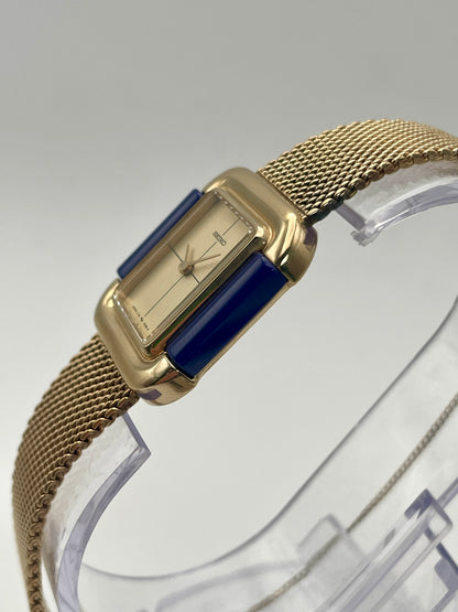 Side angle view of Seiko Hidden Crown 1719-3070 watch showing gold case and integrated mesh bracelet.