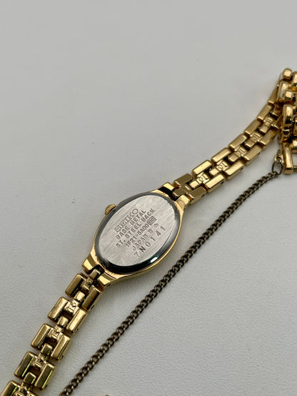 Caseback view of Seiko Oval 1F21-5A00 with model number and stainless steel markings
