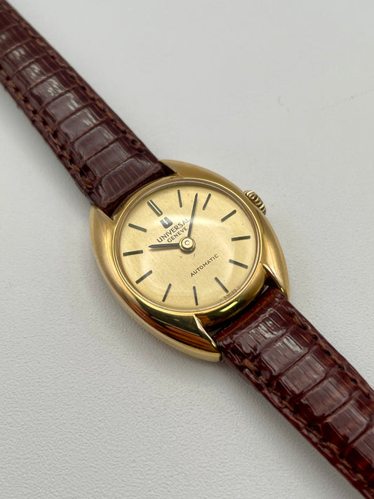 Main view showing the gold case and champagne dial of the Universal Geneve watch
