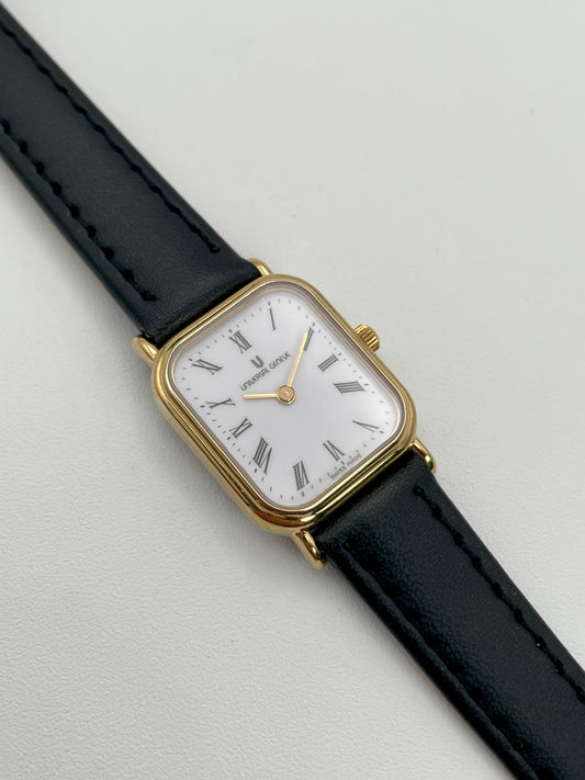 Main view of Universal Geneve Tank Vintage Women's Watch in gold case with black leather strap.
