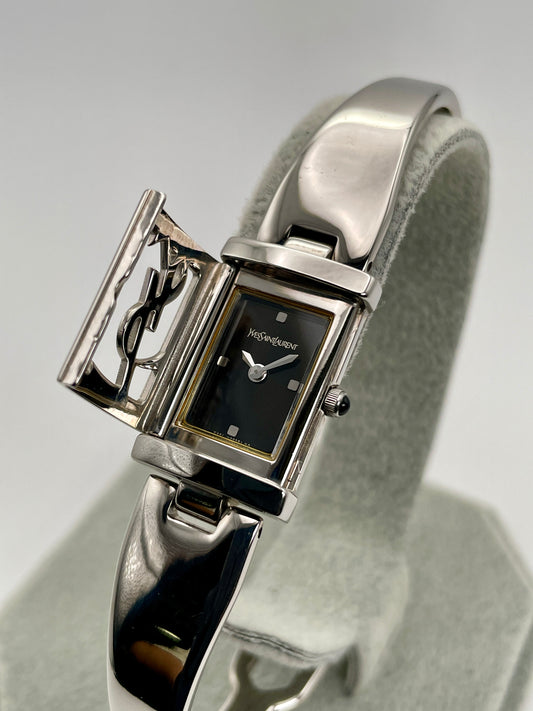 Main view of Yves Saint Laurent 40th Anniversary Women’s Watch in steel showing the dial and protective cover.
