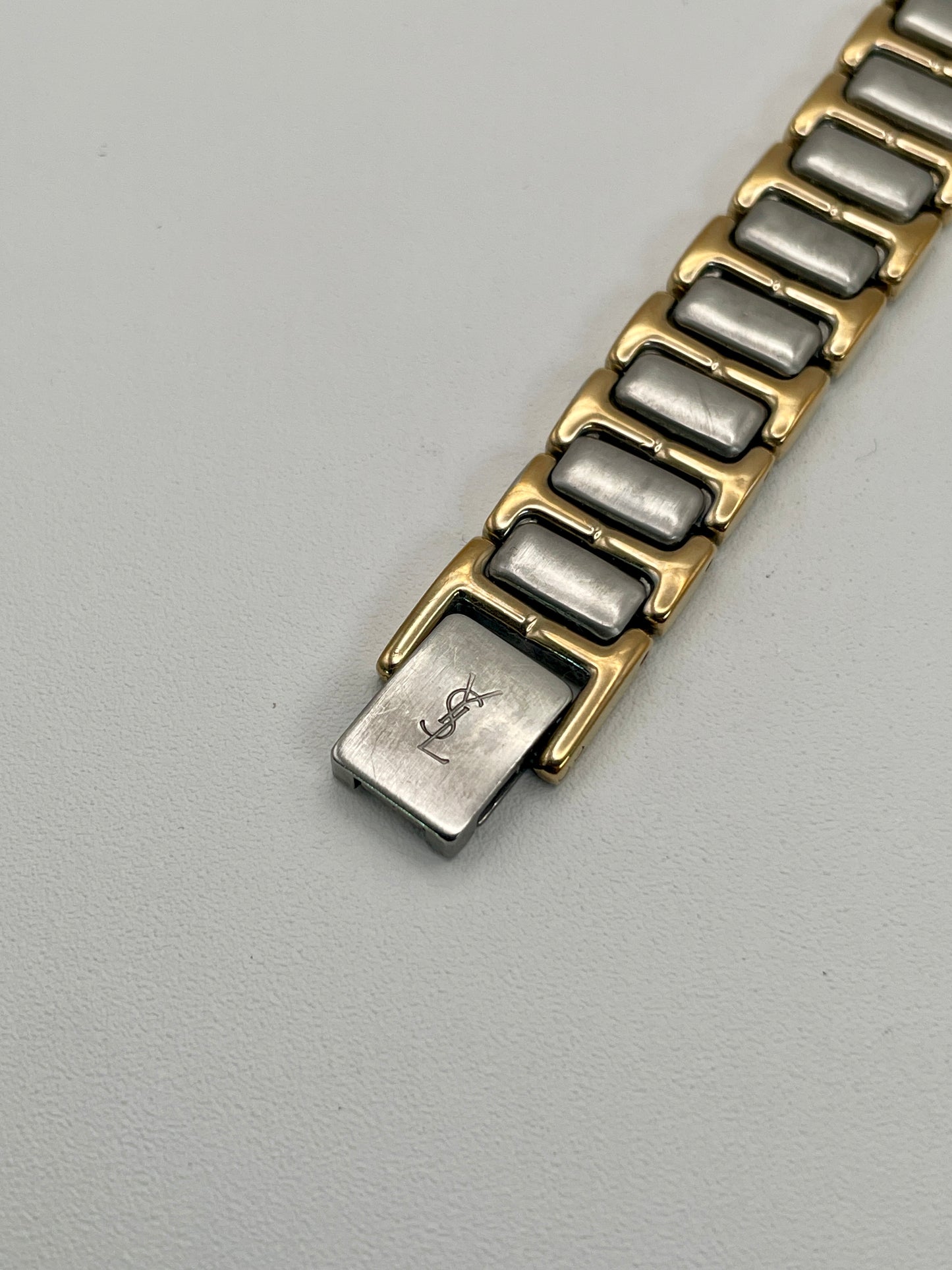 Clasp view of the YSL Black Pour Femme watch showing the YSL logo engraved on the buckle.