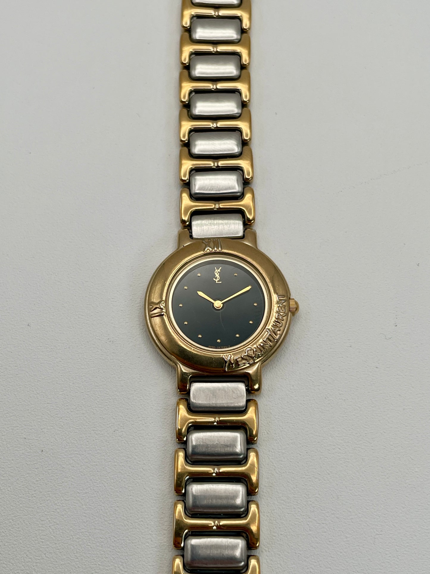 Front view of the Yves Saint Laurent Black Pour Femme vintage women's watch showcasing the black dial and gold-tone bezel.