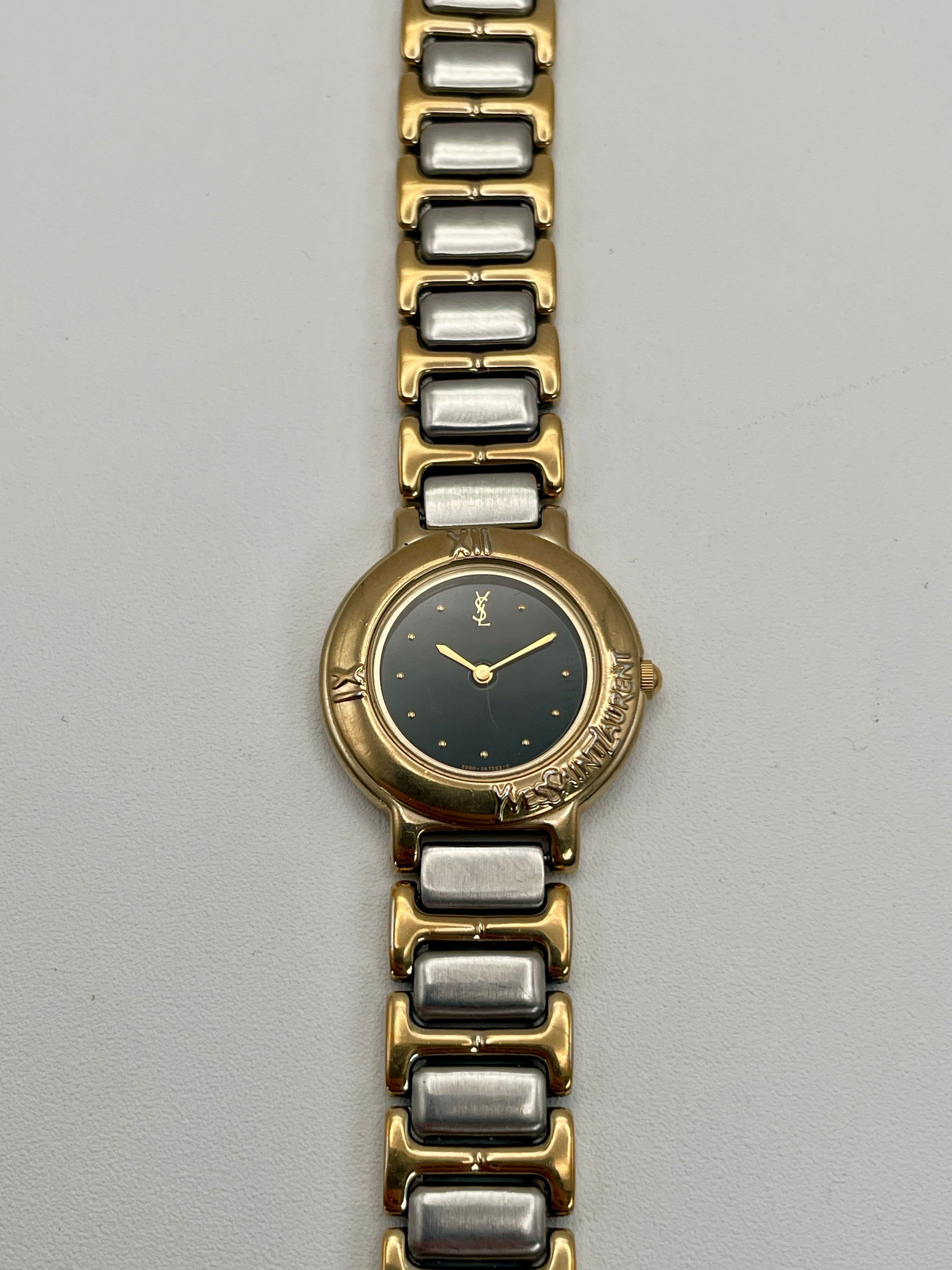 Front view of the Yves Saint Laurent Black Pour Femme vintage women's watch showcasing the black dial and gold-tone bezel.