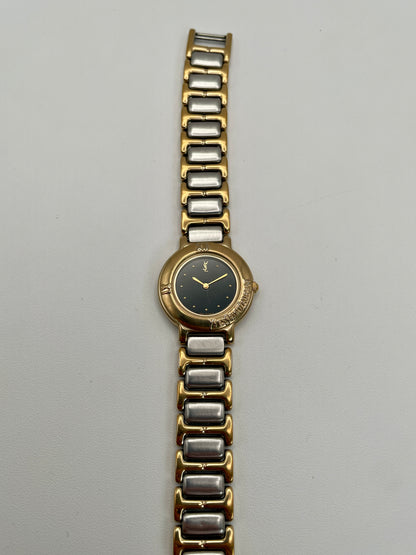 Yves Saint Laurent Black Pour Femme vintage women's watch in a gold case with two-tone bracelet.