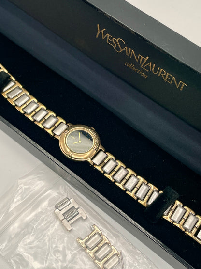 Yves Saint Laurent Black Pour Femme vintage women's watch in a gold case with two-tone bracelet, shown with original box and extra links.