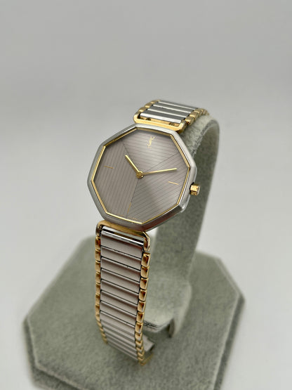 Diagonal front angle of YSL octagon vintage watch showcasing faceted case and striped dial
