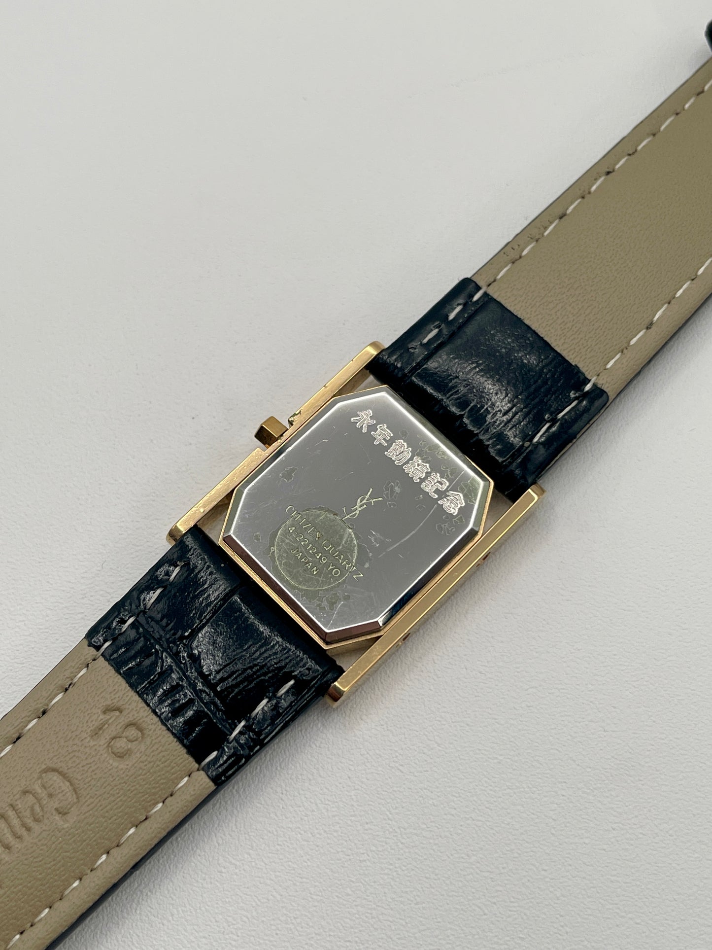 Stainless steel caseback with YSL branding and engraved Japanese markings