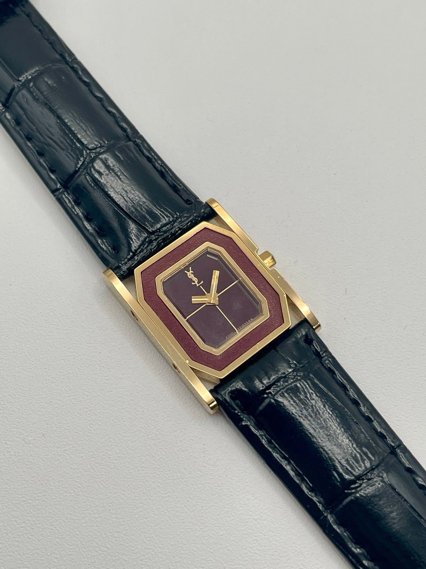 Front view of Yves Saint Laurent Tank Vintage Women's Watch in gold with burgundy dial