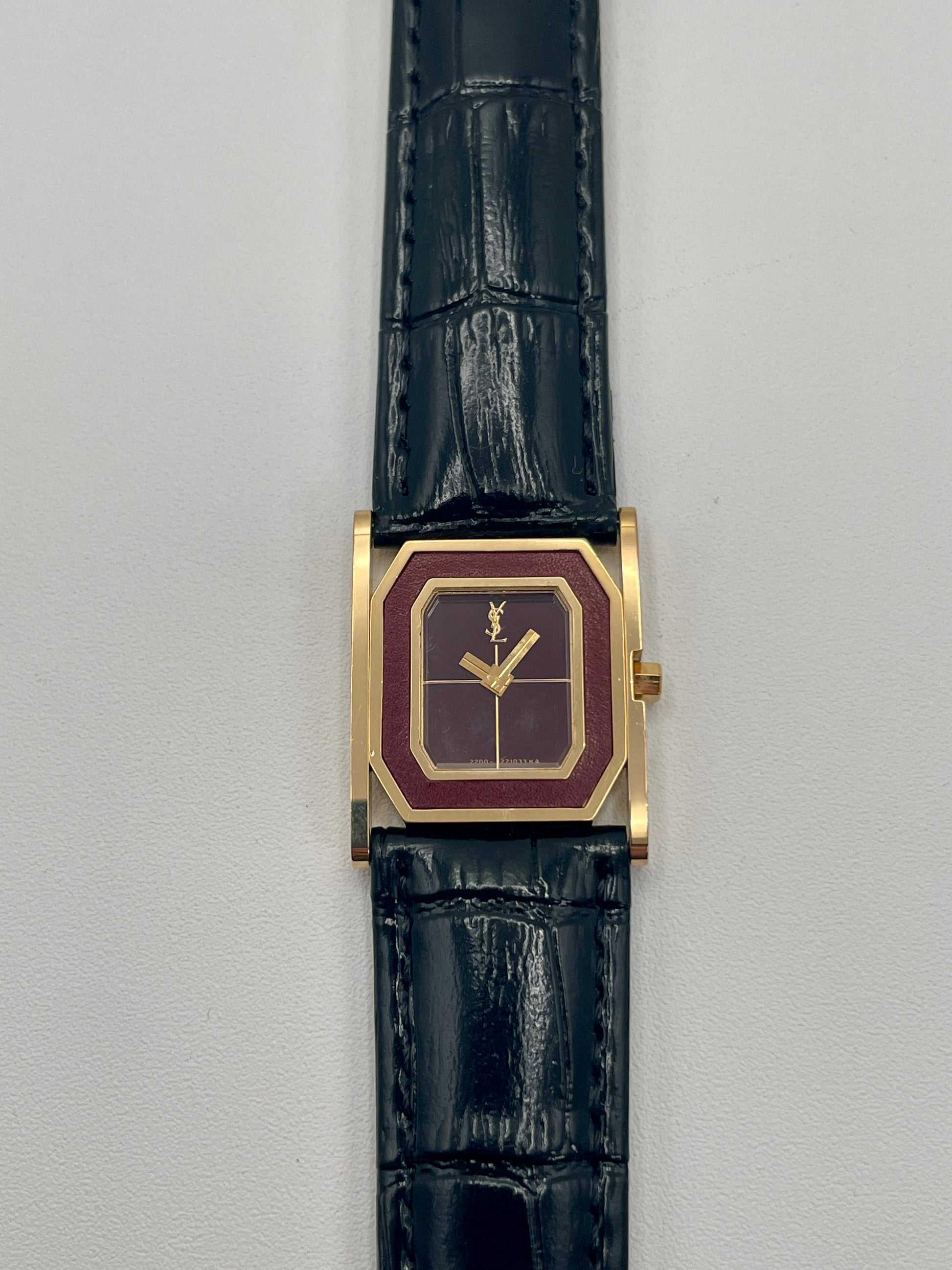 Front view of Yves Saint Laurent Tank Vintage Women's Watch in gold with burgundy dial