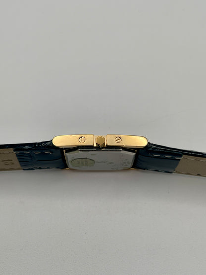 Right side view of the YSL watch showing the gold crown and screw accents
