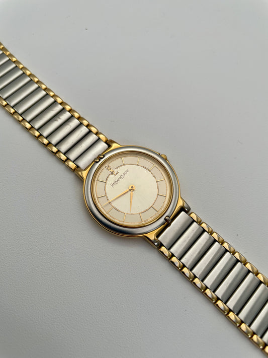 Vintage Yves Saint Laurent two-tone watch with a gold and silver-tone bracelet, showing the front view of the watch dial.