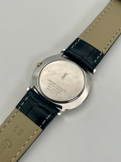 Caseback view of Yves Saint Laurent vintage watch, showing the polished steel back.
