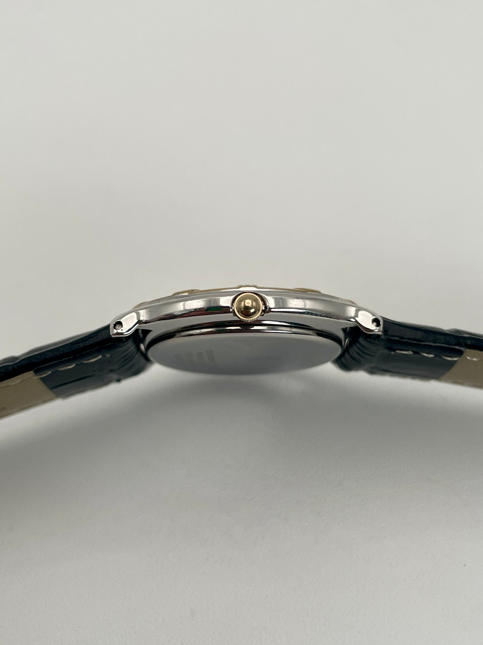 Side view of Yves Saint Laurent vintage watch with a slim gold crown.