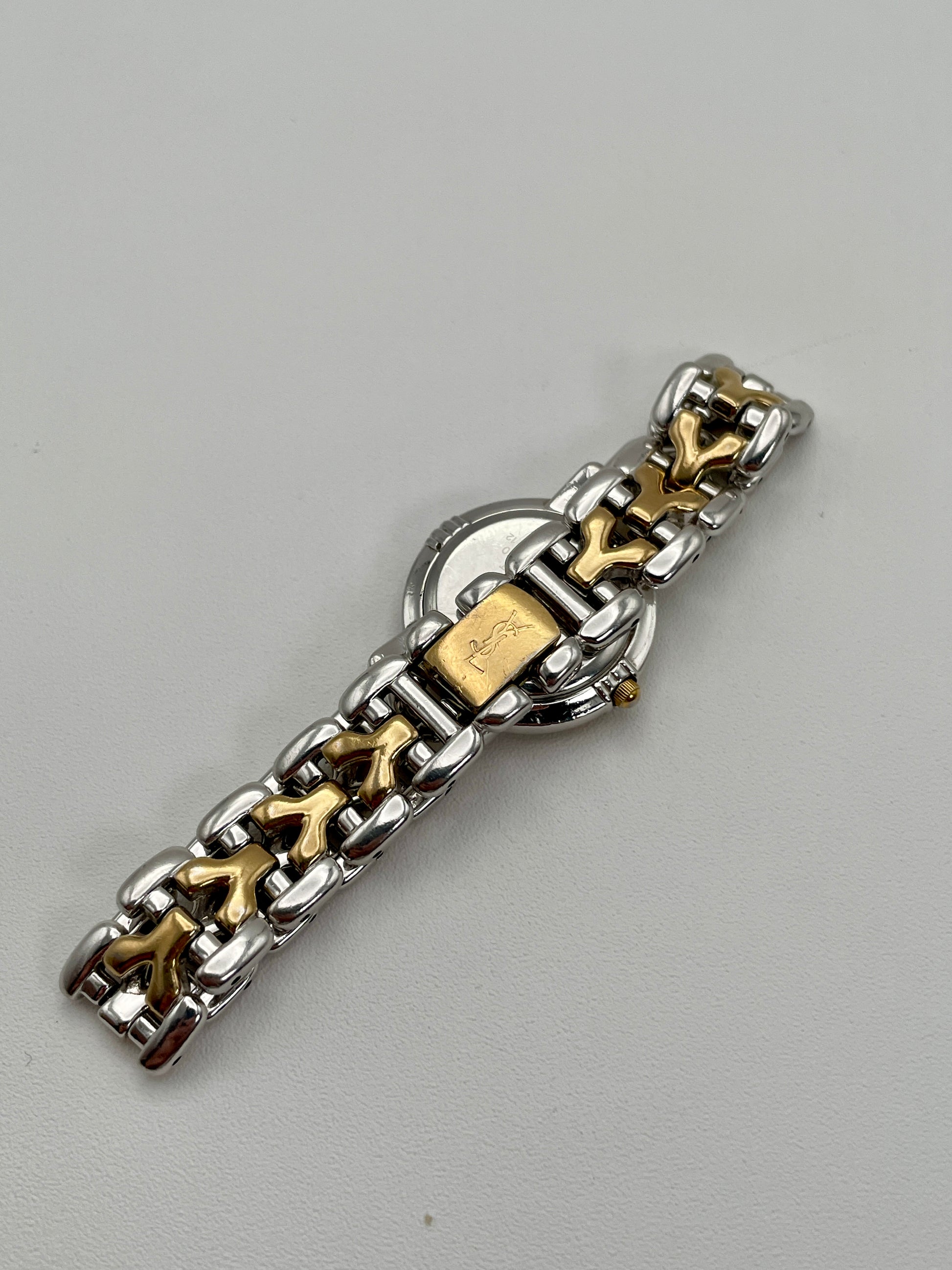 Clasp view of Yves Saint Laurent vintage women's watch highlighting the engraved YSL logo on the gold-tone clasp

