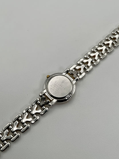 Caseback view of Yves Saint Laurent vintage women's watch showing engraved details and serial number

