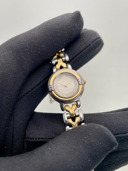 Close-up view of Yves Saint Laurent vintage women's watch focusing on the dial and bracelet texture
